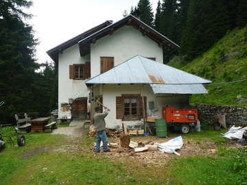 Preparing wood for cooking dinner at Malga Antola